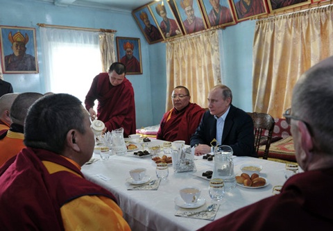 Vladimir Putin having tea with the lamas of the Ivolga datsan.